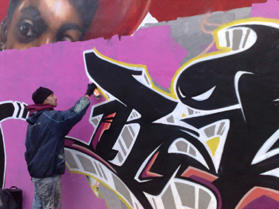 Rarebit (real name Craig Jones) from Port Talbot works on a piece at a legal wall site in Roath